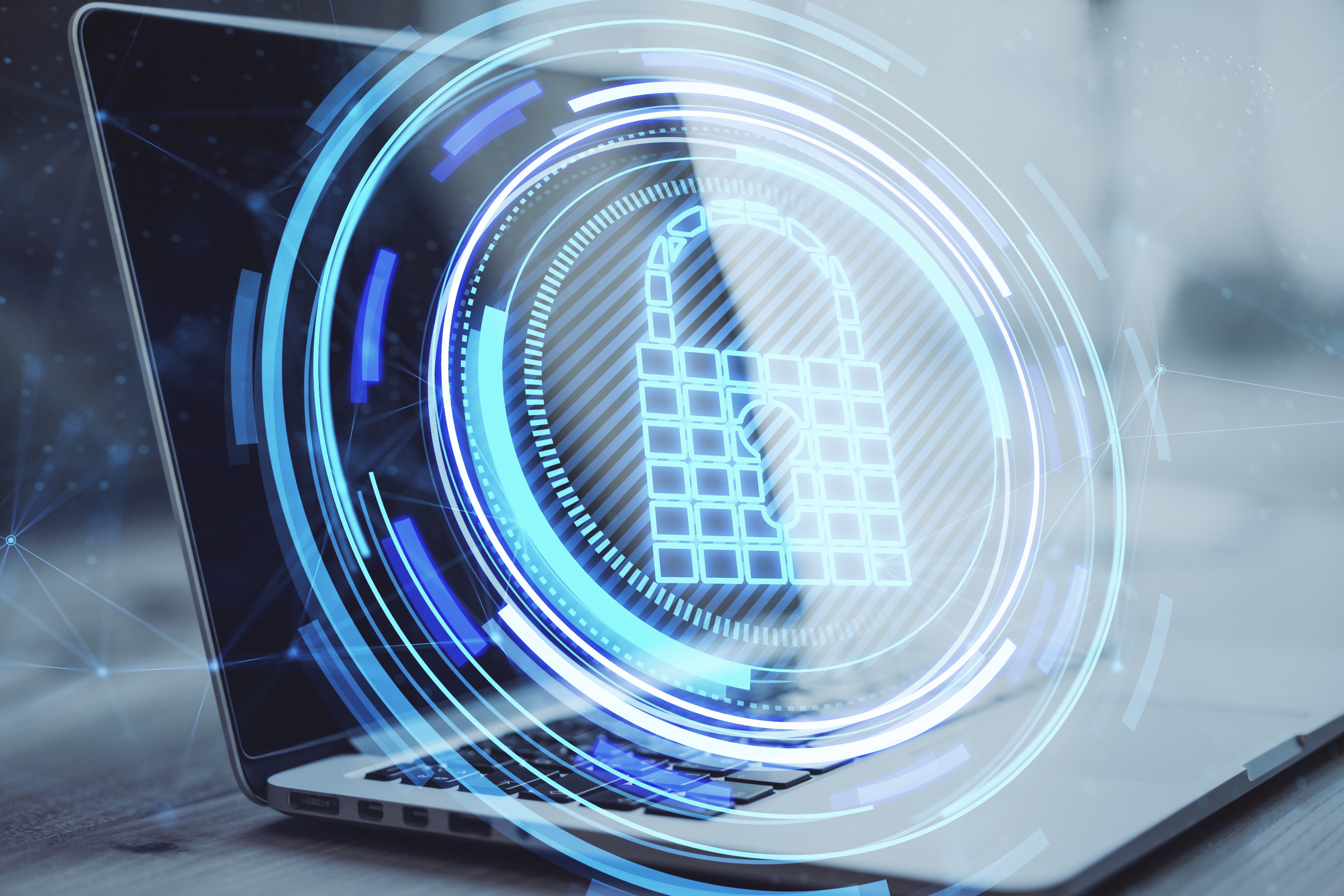 close-up-laptop-computer-desktop-with-creative-glowing-blue-padlock-hologram-blurry-background-secure-safety-database-web-protection-concept-double-exposure